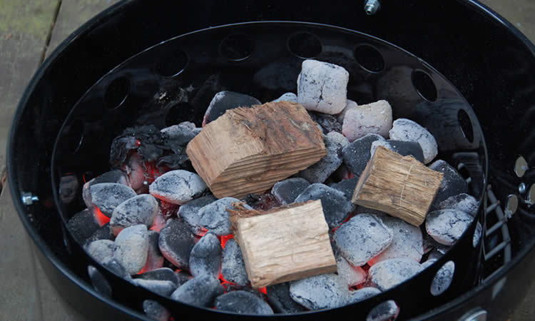 Wood chunks over charcoal