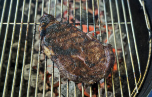 steak on charcoal grill