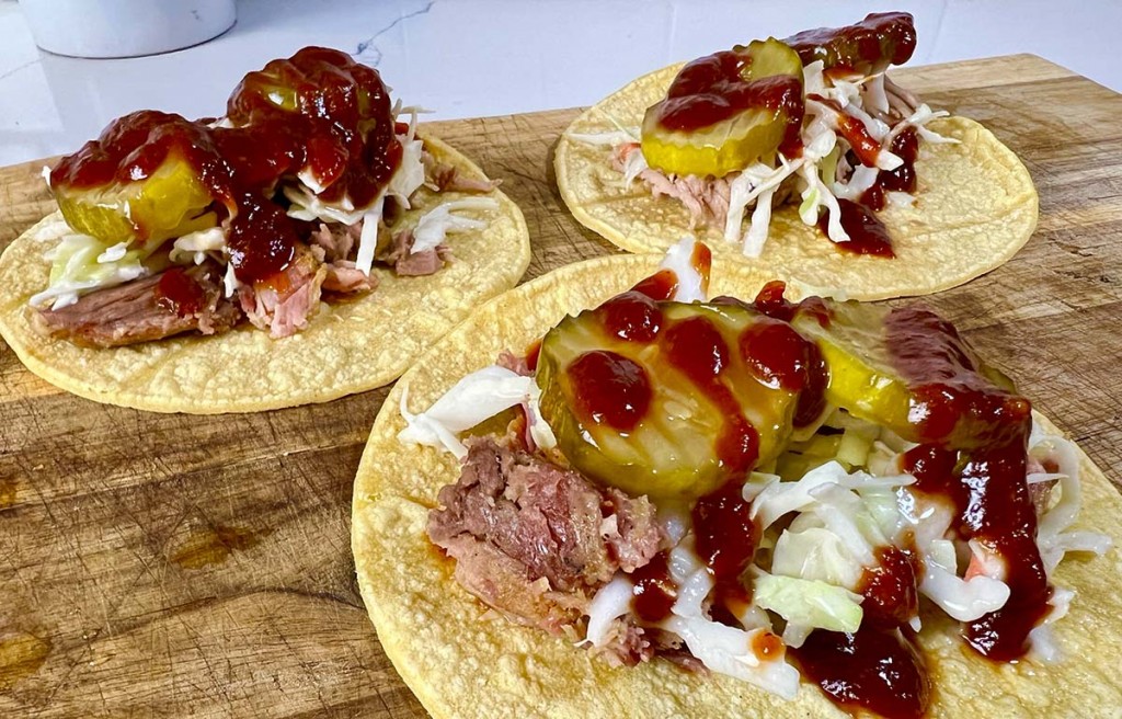 tacos made from leftover pulled pork with pickles and bbq sauce
