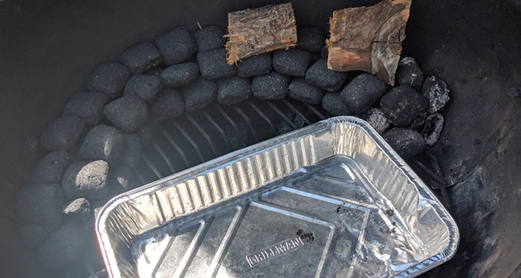 Charcoal stacked into a snake in weber kettle grill