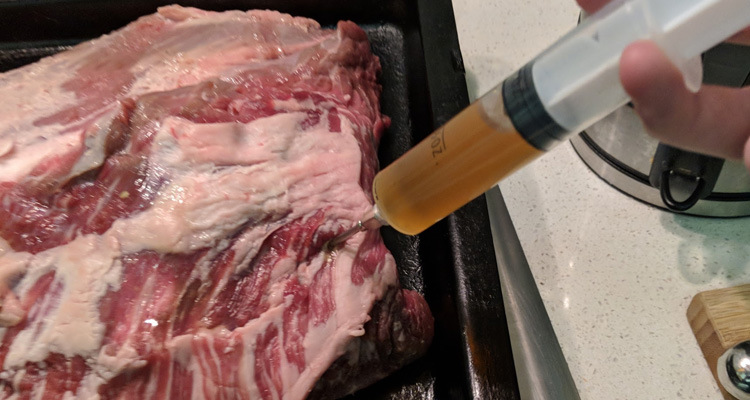 injecting a beef brisket