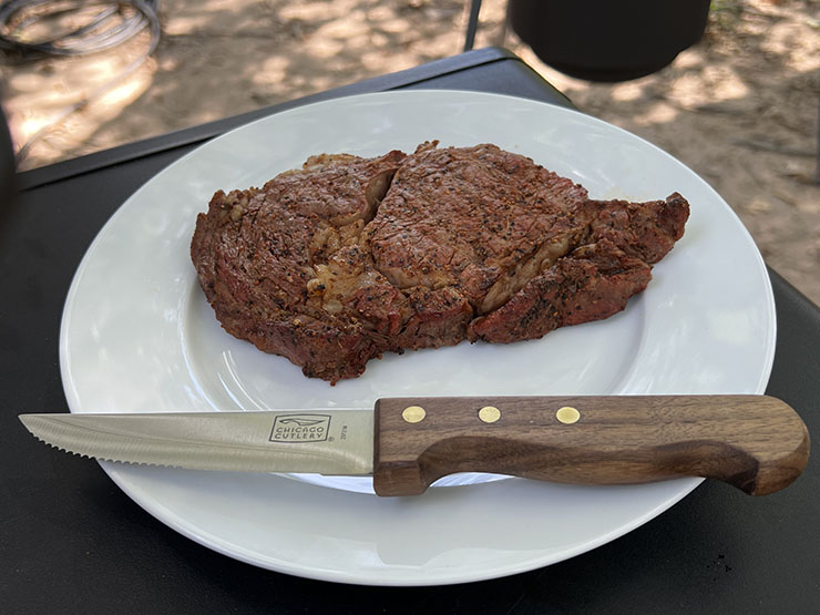 Chicago Cutlery steakhouse knife on a white place with a piece of steak