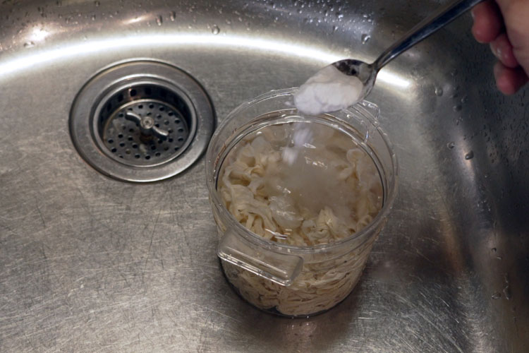baking soda being added to tub of water and hog casings