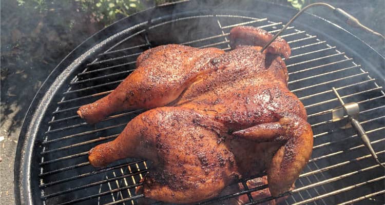 Chicken cooking on smoker with temperature probe