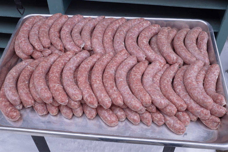 tray of uncooked brats