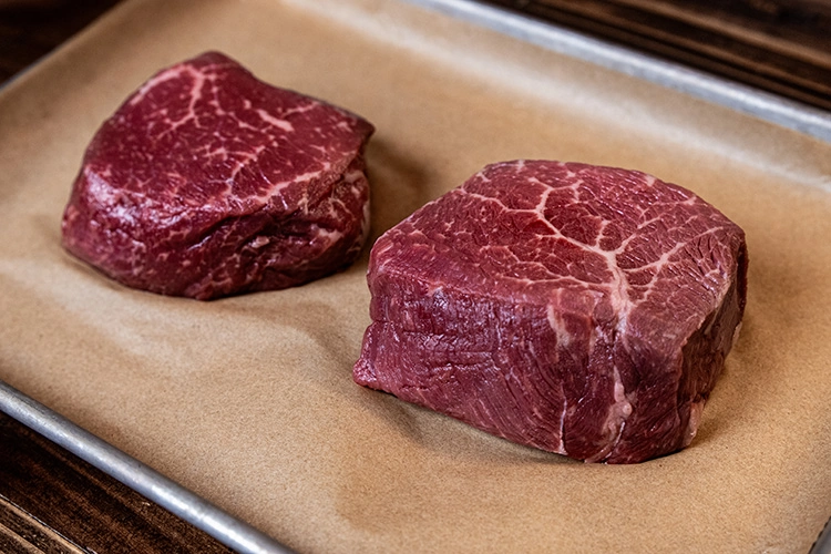 raw beef top sirloin steak on brown butcher paper