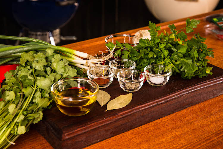 Ingredients for chimichurri sauce on a wooden board