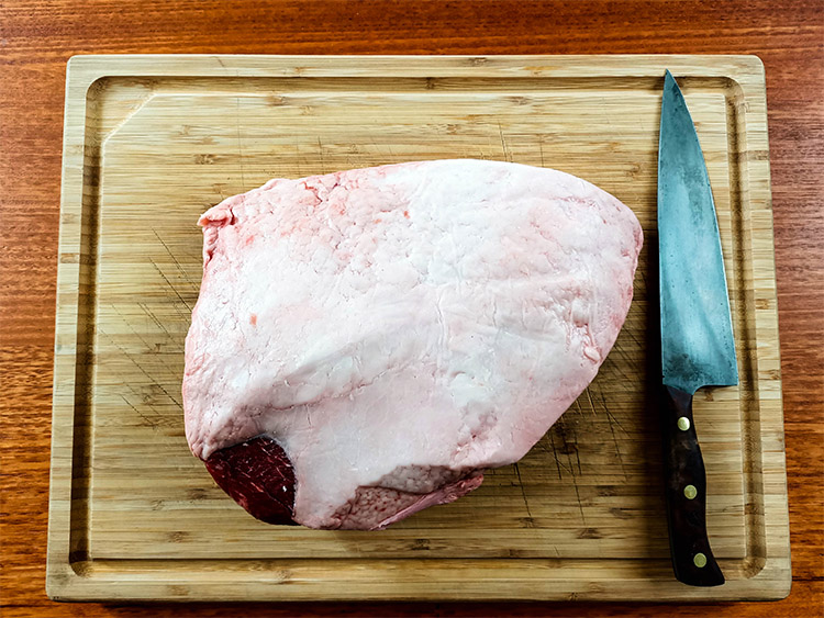a rump cap and a knife on a wooden board
