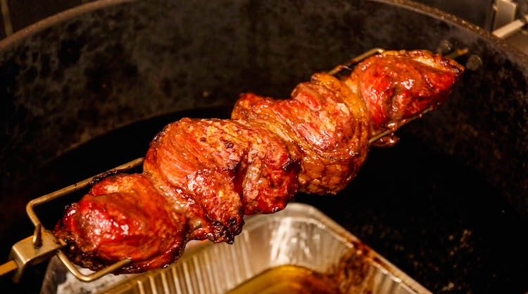 cooked picanha steak on a rotisserie