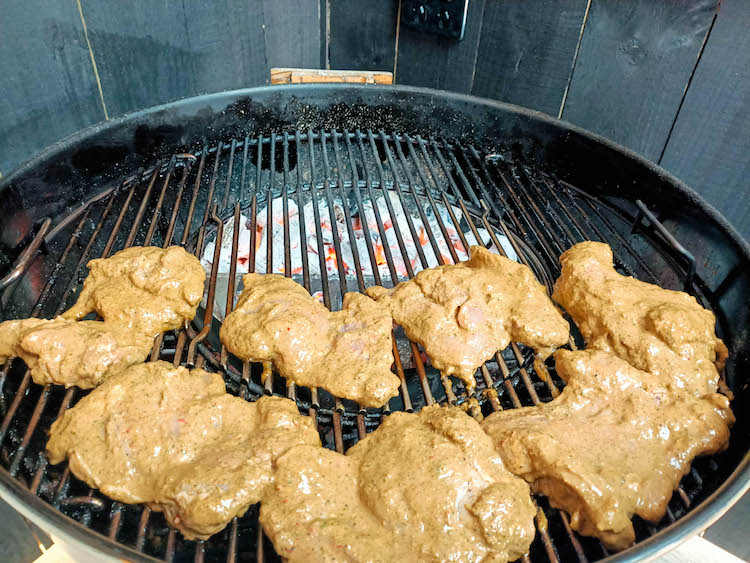 chicken thighs in jerk marinade on a grill
