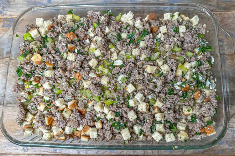 uncooked stuffing mixture in glass pan