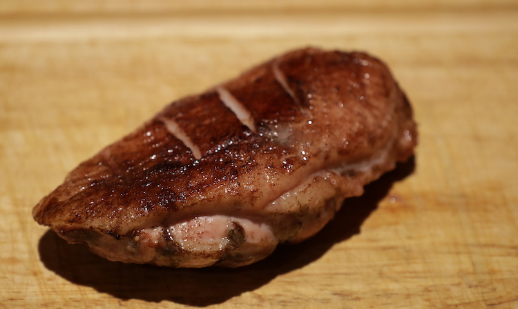 smoked duck breast on a wooden board