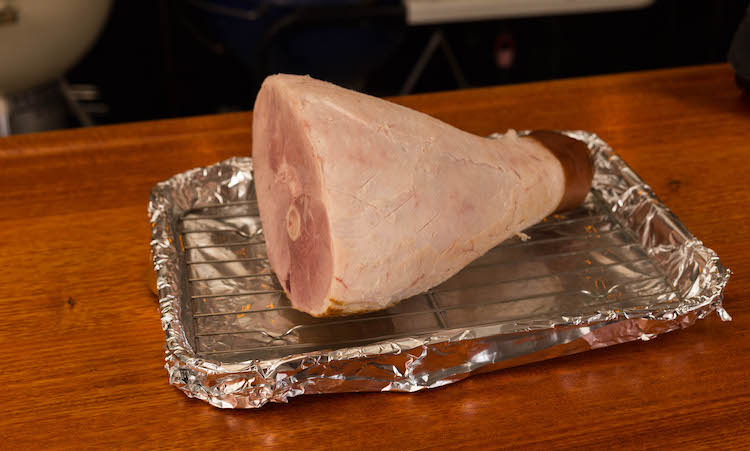 ham with skin removed on a wire rack