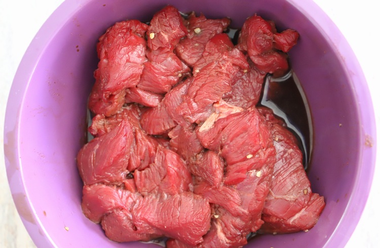 sliced beef in a plastic bowl