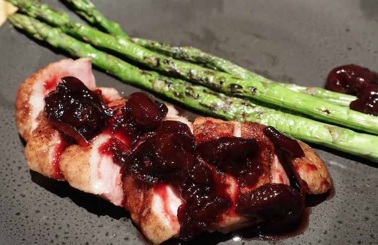 smoked duck breast with cherry orange sauce and asparagus
