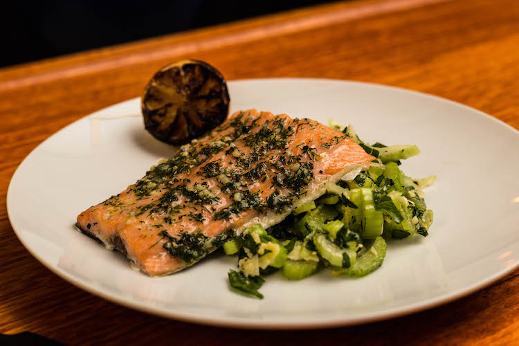 cedar planked salmon with celery and parmesan salad on a plate