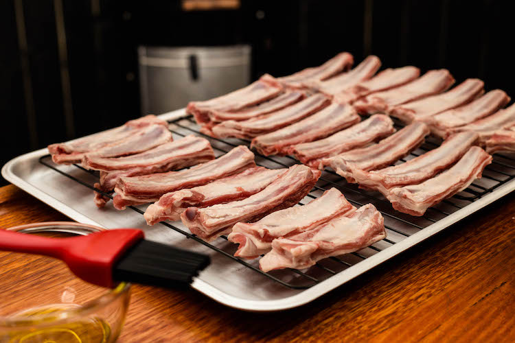 raw lamb ribs on a metal tray
