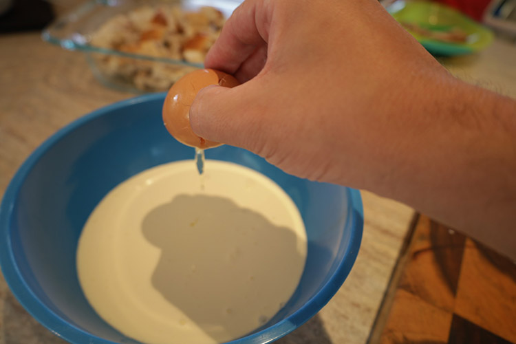 mixing cooking cream with eggs in s bowl