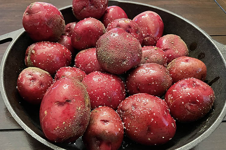 seasoned red potatoes on cast iron skillet