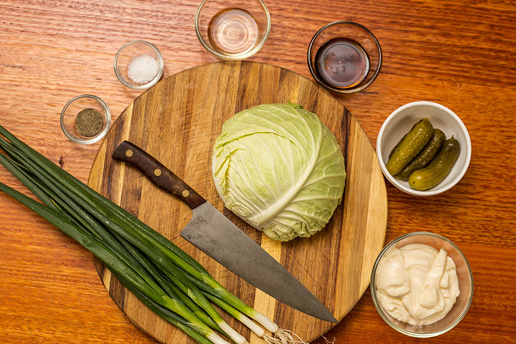 creamy sweet slaw ingredients on a wooden table