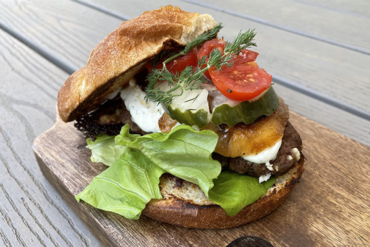 Mediterranean lamb burger on a wooden board