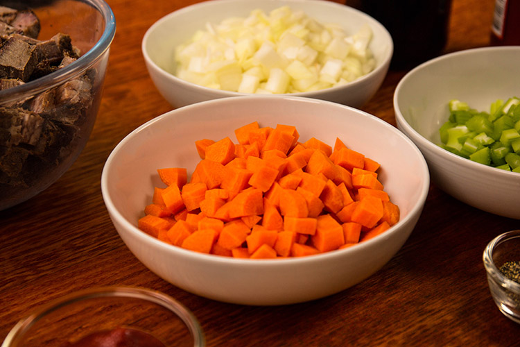 diced carrots and onions in bowls
