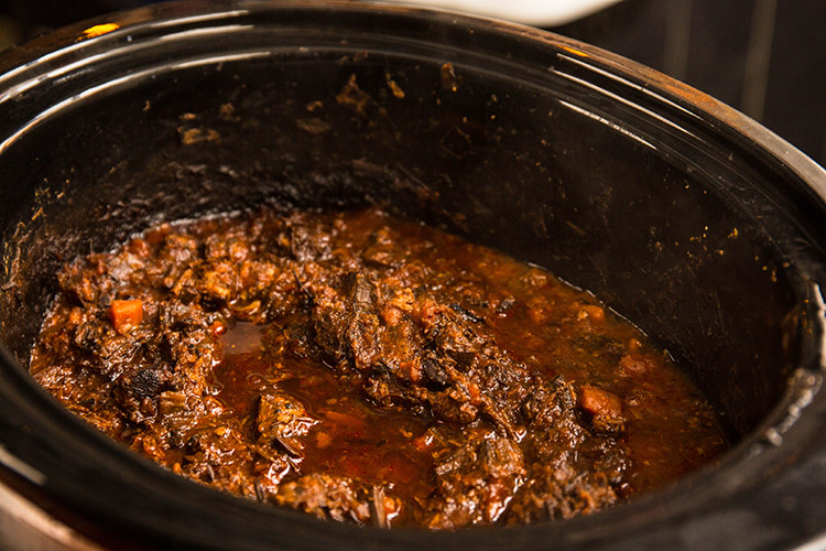 cooked leftover brisket bolognese sauce in a slow cooker