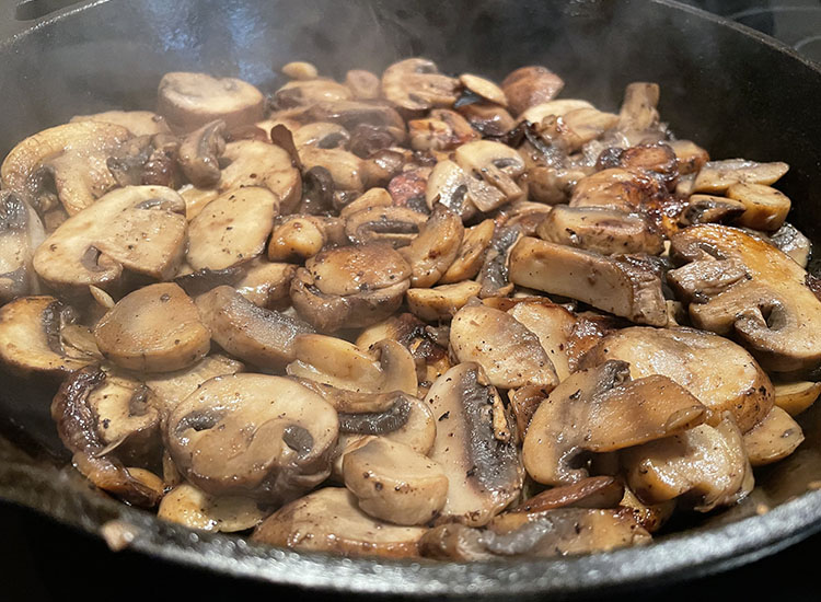 cooked bella mushrooms in a pan