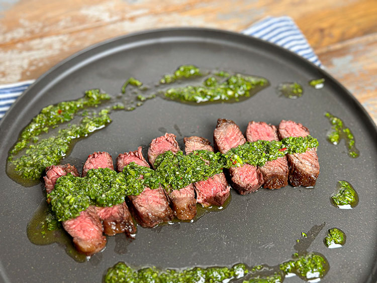 grilled rump cap steak on palte with chimichuri sauce