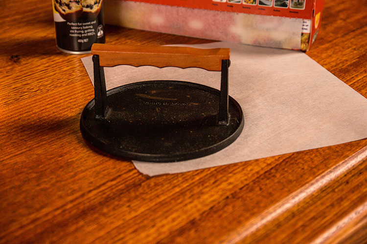 burger smasher on a wooden table