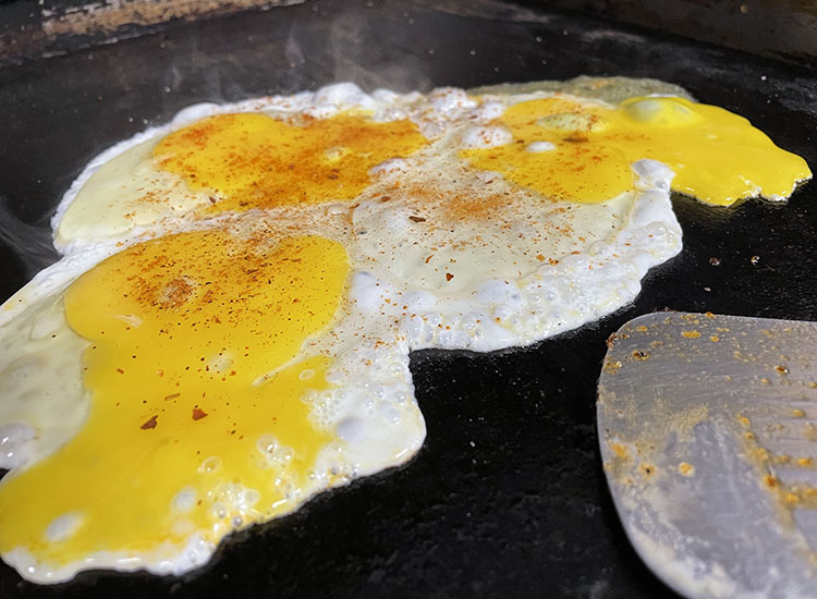 eggs cooking on a griddle