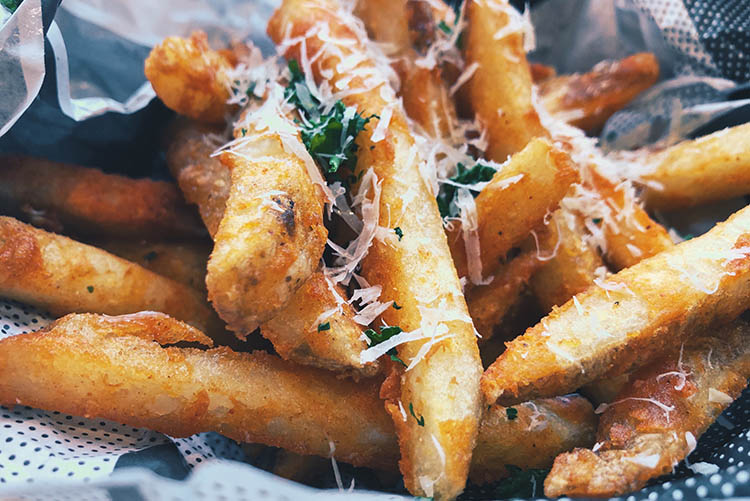 french fries with cheese and herbs