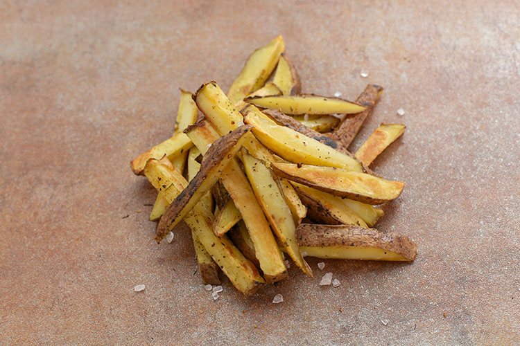 seasoned french fries on a parchment paper