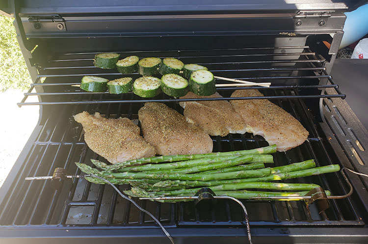 chicken breasts and vegetables cooking on Bit Boss Sportsman Pellet Grill