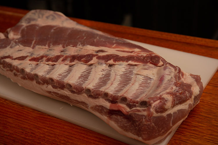 raw pork spare ribs on a plastic board