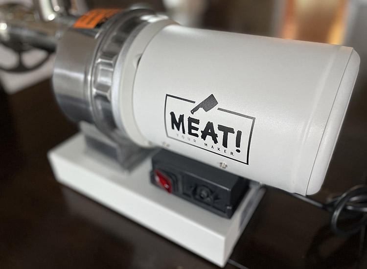 meat! your maker grinder with a logo close up