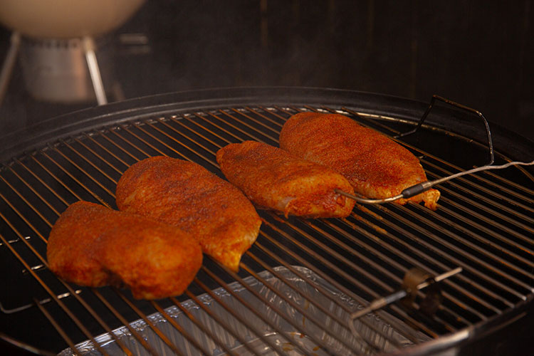 Chicken breasts in the smoker with a temperature probe