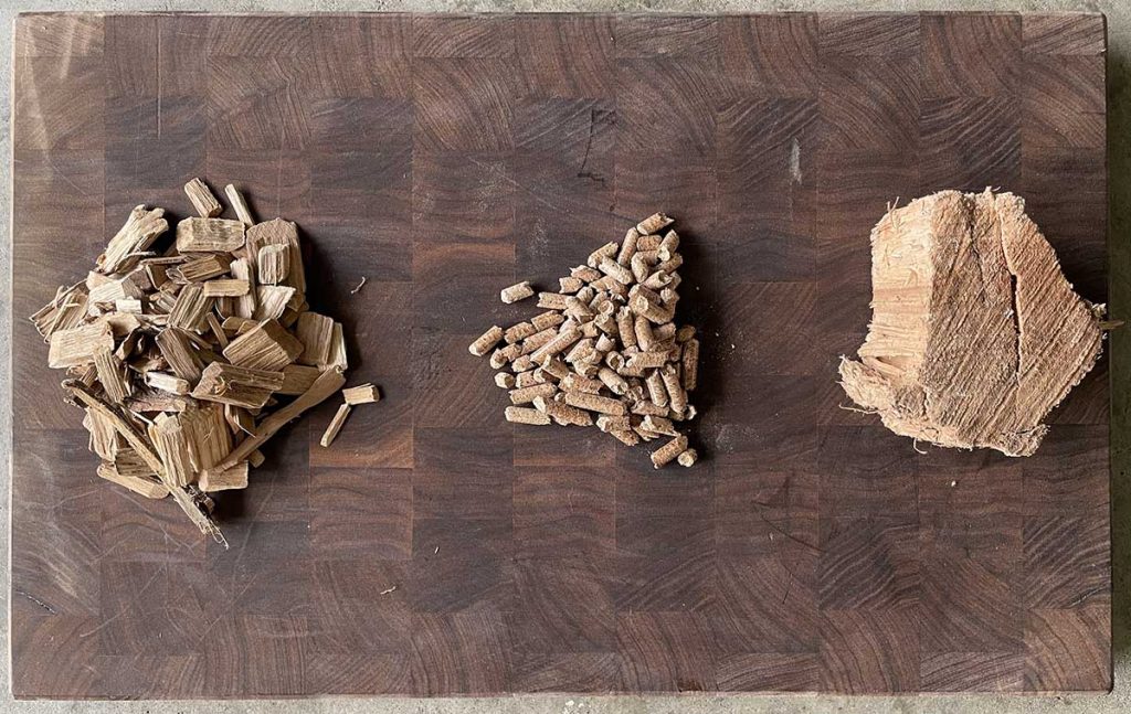 wood chips, pellets and chunk on a wooden board