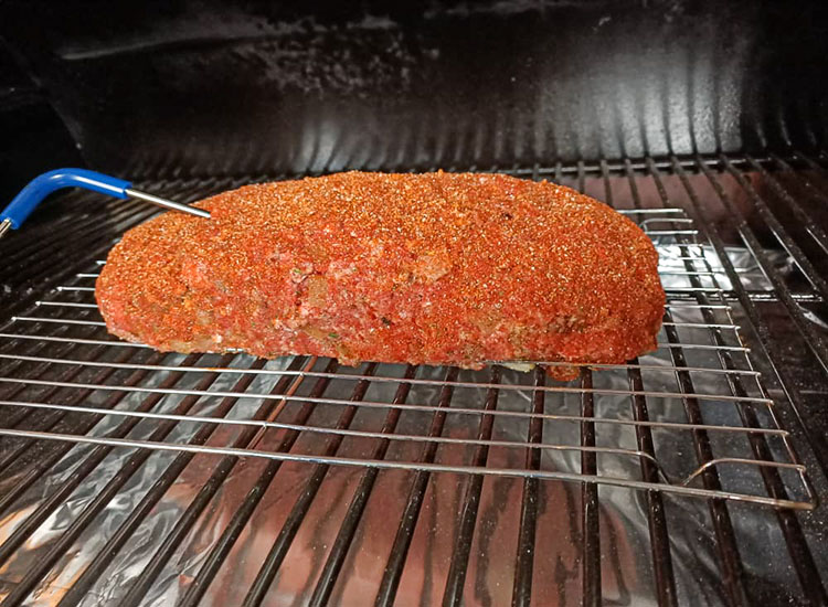 uncooked meatloaf in a smoker