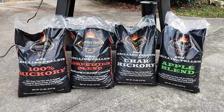 four bags of wood pellets on the ground
