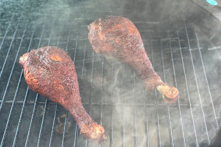 turkey legs on grill with smoke haze