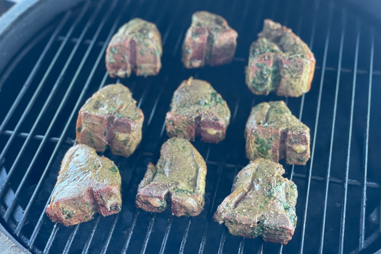 lamb chops cooking on a grill