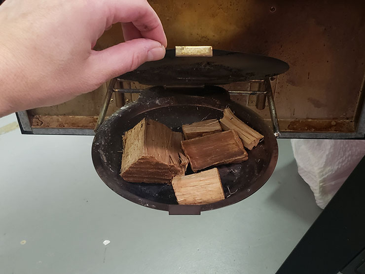 Masterbuilt MPS 340/G propane smoker wood bowl with wood chunks inside