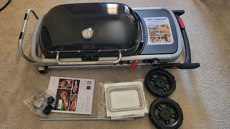 weber traveler gas grill unassembled on the floor 