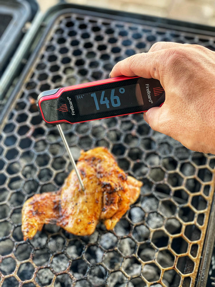 FireBoard Spark instant-read thermometer showing an internal temperature of a grilled chicken wing