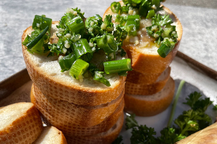 crostini smeared with marrow bone and topped with parsley salad