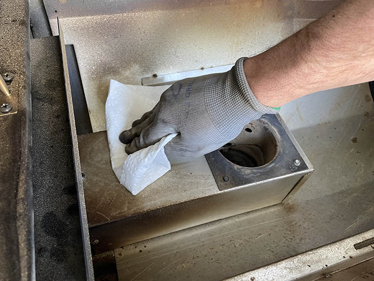 wiping pellet grill cooking chamber with paper towel