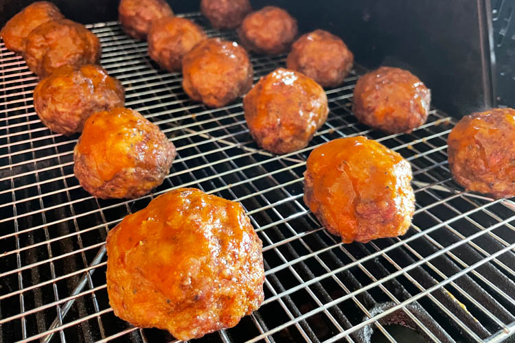 glazed meatballs on a wire rack in the grill