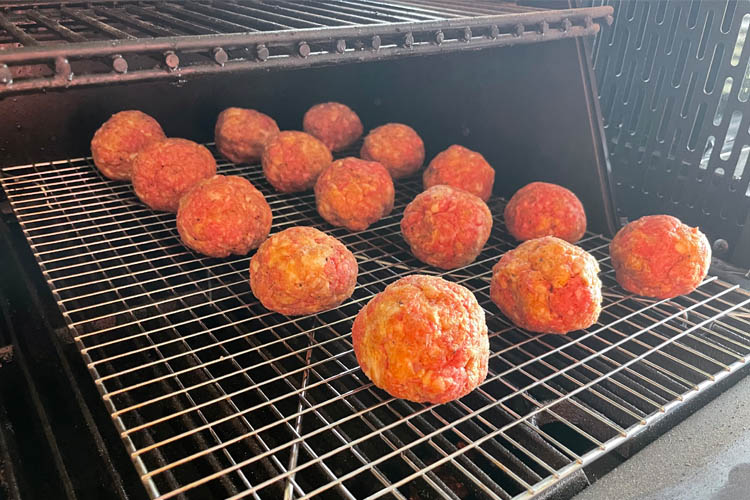 meatballs on a wire rack in the grill
