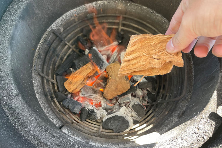 fire and wood chips inside a green egg